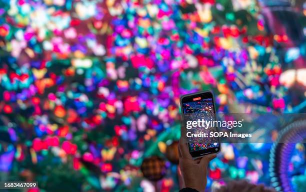 Visitor takes pictures at the "The Butterfly Trail" event. Pixel Artworks launched "The Butterfly Trail" at Outernet London on September 5. This...