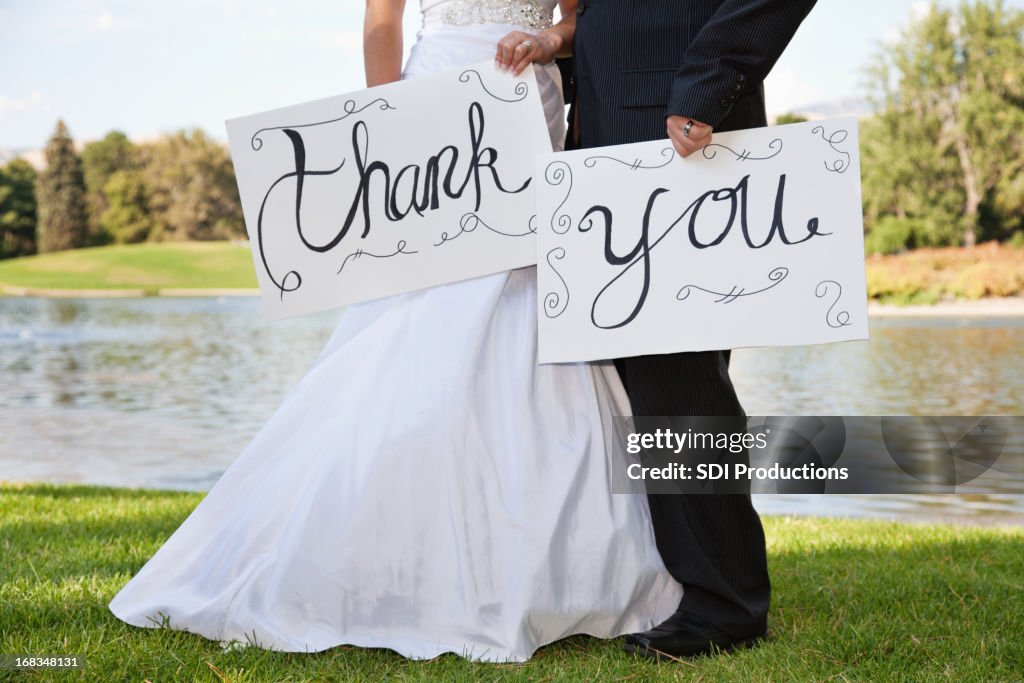 Young Wedding Couple Holding Thank You Signs