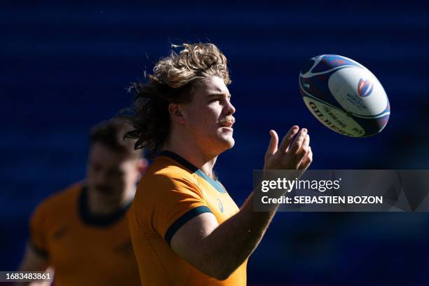 Australia's flanker Fraser McReight plays with a ball during the captain's run training session at OL Stadium in Decines-Charpieu, southeastern...