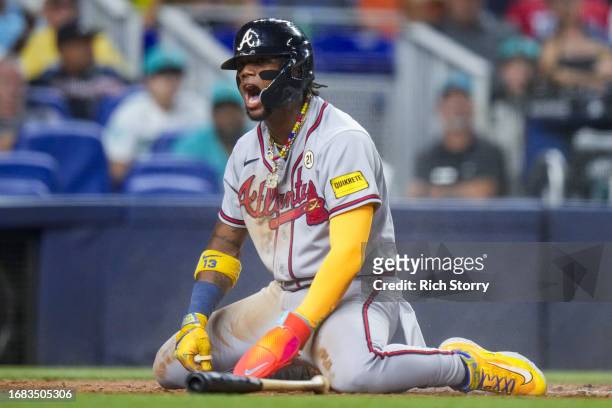 Ronald Acuna Jr. #13 of the Atlanta Braves celebrates after scoring against the Miami Marlins during the third inning at loanDepot park on September...