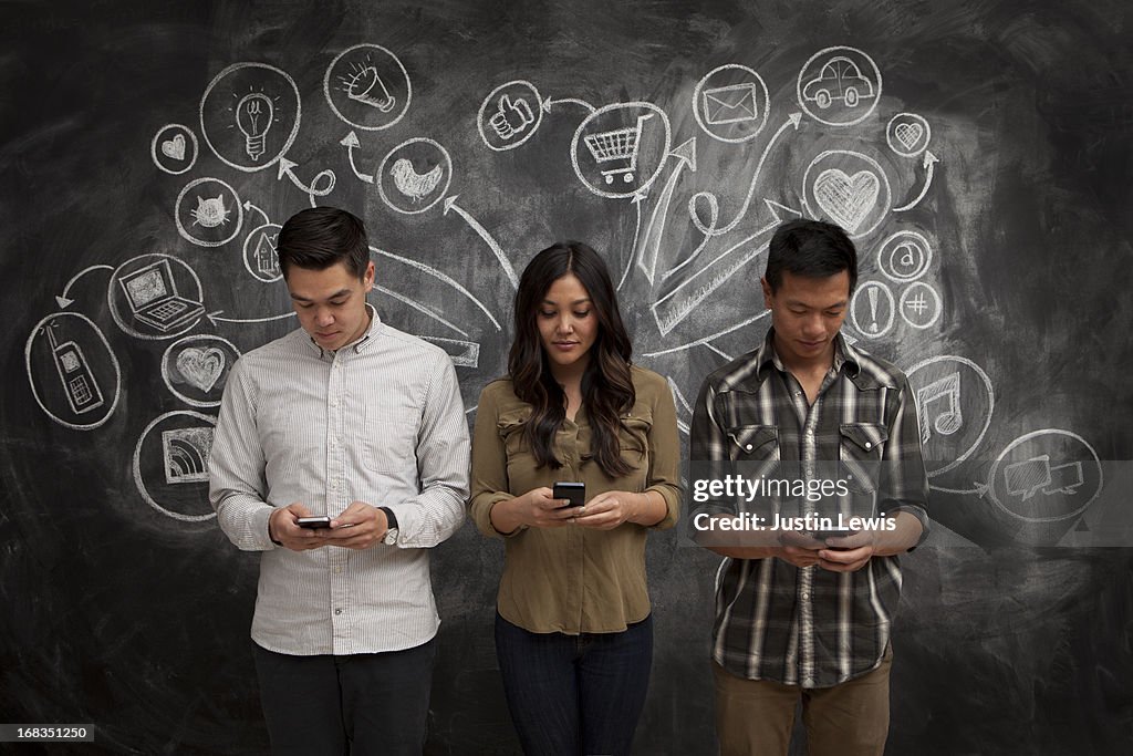 People on phones with social media icon chalkboard