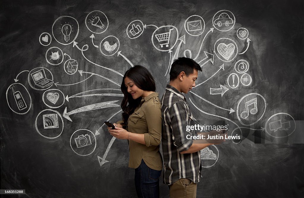 People on phones with social media icon chalkboard