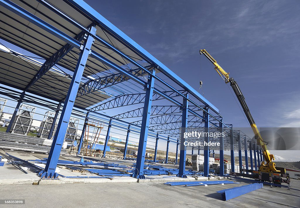A crane working on a factory building