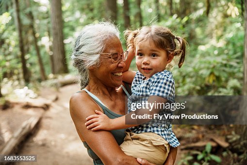 Vibrant Pacific Islander senior woman hiking with Eurasian granddaughter Vibrant Pacific Islander senior woman hiking with Eurasian granddaughter