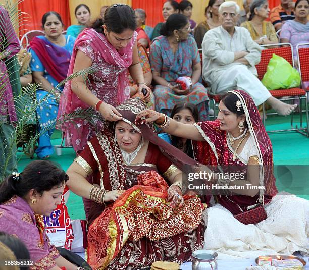 Women getting ready for the puja during Karva Chauth at Dussehra park, Janakpuri on October 26, 2010 in New Delhi, India.