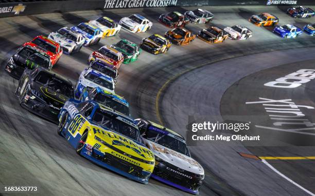 Dale Earnhardt Jr., driver of the Hellmann's Chevrolet, and Chandler Smith, driver of the Barger Precast Chevrolet, race during the NASCAR Xfinity...