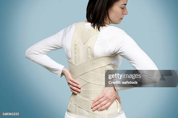 corset for backache - women in girdles stock pictures, royalty-free photos & images