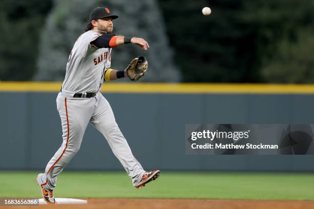Brandon Crawford of the San Francisco Giants throws out Nolan Jones of the Colorado Rockies in the first inning at Coors Field on September 15, 2023...