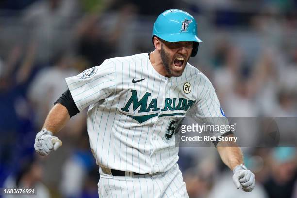 Jacob Stallings of the Miami Marlins reacts after hitting a double to clear the bases against the Atlanta Braves during the eighth inning at...