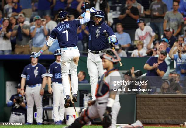 Salvador Perez of the Kansas City Royals congratulates Bobby Witt Jr. #7 after Witt hit a solo hoe run during the 5th inning of the game against the...