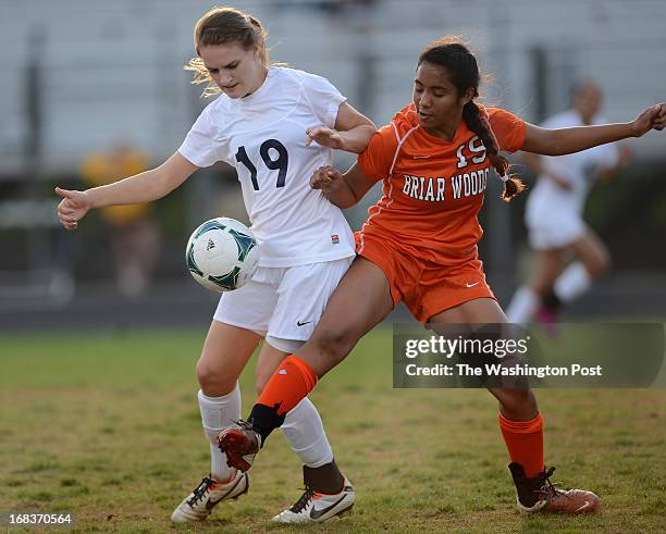 Stone Bridge's Ashley Herndon, left, and Briar Woods' Mia Venkat, right, battle for the ball during the game at Stone Bridge High School on...