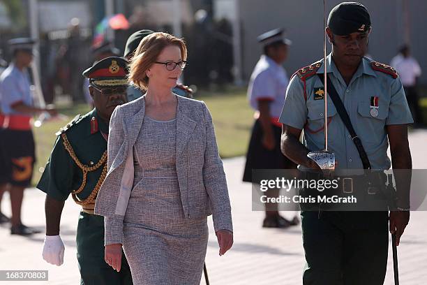 Australian Prime Minister Julia Gillard inspects the honour guard after arriving at Jackson International Airport on May 9, 2013 in Port Moresby,...