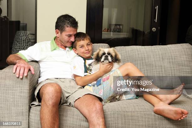 Joost van der Westhuizen poses with his son Jordan, and his dog Buddy at his new home on April 22, 2013 in Dainfern, Johannesburg, South Africa. His...