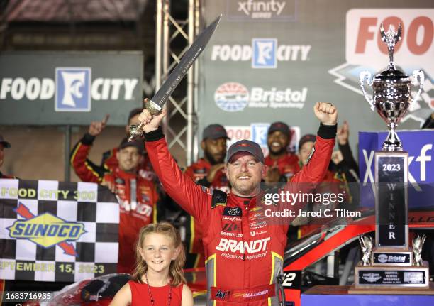 Justin Allgaier, driver of the BRANDT Chevrolet, celebrates with his daughter, Harper Allgaier in victory lane after winning the NASCAR Xfinity...