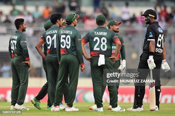 New Zealand's Ish Sodhi speaks with Bangladesh's players during the second one-day international cricket match between Bangladesh and New Zealand at...