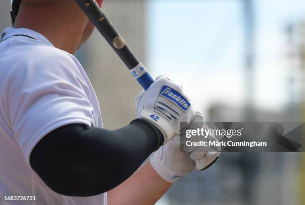 Detailed view of the custom Franklin Jackie Robinson Day batting gloves worn by Spencer Torkelson of the Detroit Tigers as he waits on-deck to bat...