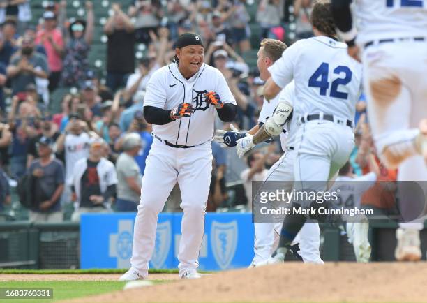 Miguel Cabrera of the Detroit Tigers celebrates with teammates after hitting a game-winning single in the bottom of the 11th inning of the game...