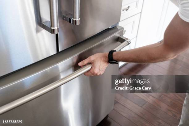 man opens freezer door - gefrierschrank stock-fotos und bilder