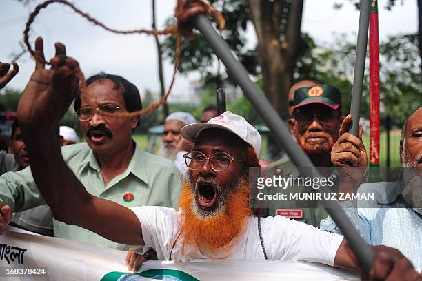 Activists and former freedom fighters who fought against Pakistan in the 1971 war demonstrate against the verdict on Mohammad Kamaruzzaman outside...