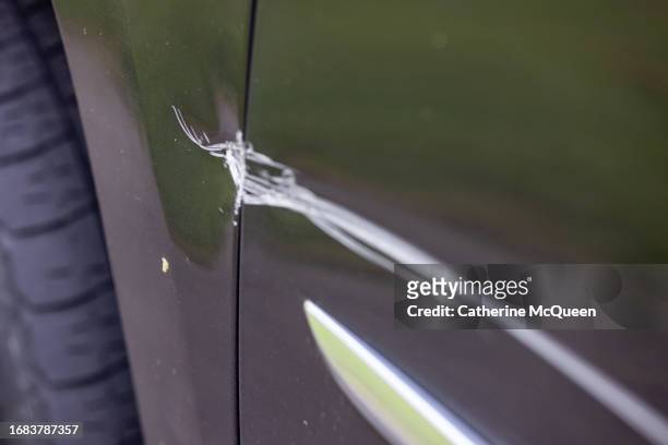 damage to rear side panel of car following traffic accident - scratched car stock pictures, royalty-free photos & images
