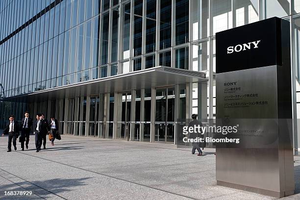 Pedestrians walk past the Sony Corp. Headquarters in Tokyo, Japan, on Thursday, May 9, 2013. Sony forecast annual profit that missed analyst...