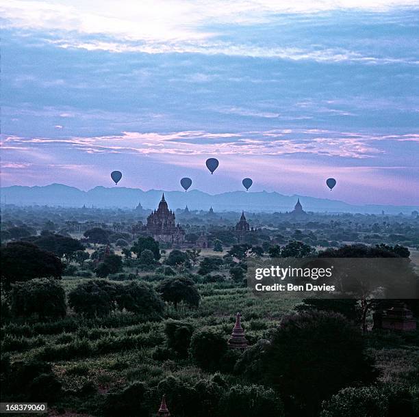 At sunrise five hot air balloons fly over the great ancient temples of Bagan as viewed from the Shwesandaw Temple. In all, there are more than 2,000...