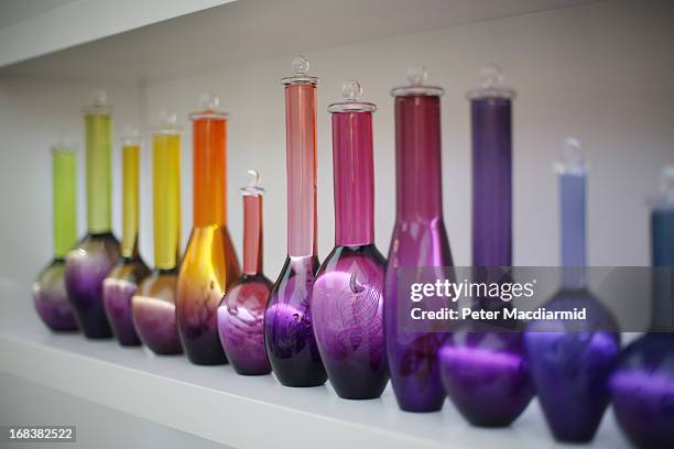 Line of coloured vases is shown at the Collect art fair at Saatchi Gallery on May 9, 2013 in London, England. Celebrating its 10th anniversary this...