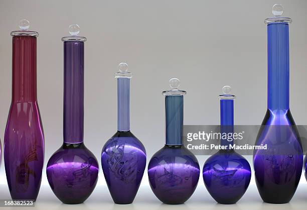 Line of coloured vases is shown at the Collect art fair at Saatchi Gallery on May 9, 2013 in London, England. Celebrating its 10th anniversary this...