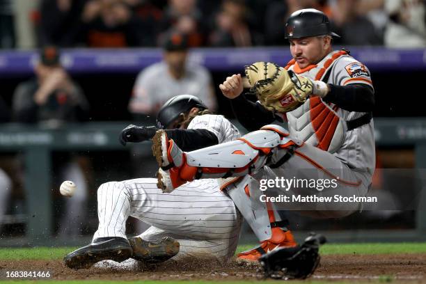 Charlie Blackmon of the Colorado Rockies scores on a Elehuris Montero single against catcher Patrick Bailey of the San Francisco Giants in the ninth...