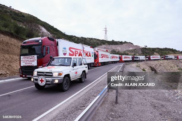 This photograph taken from the Armenian side of the border near the town of Kornidzor, on September 23 shows a vehicle of a Red Cross convoy passing...