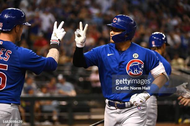 Seiya Suzuki of the Chicago Cubs celebrates with Yan Gomes after hitting a two-run home run against the Arizona Diamondbacks during the ninth inning...