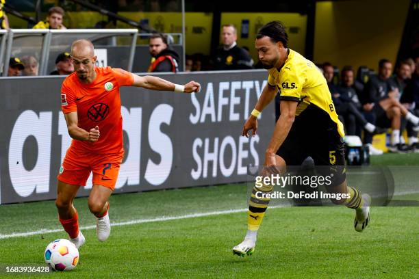 Vaclav Cerny of VFL Wolfsburg and Ramy Bensebaini of Borussia Dortmund battle for the ball during the Bundesliga match between Borussia Dortmund and...