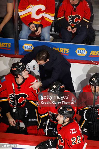 Assistant Coach Martin Gelinas talks to Roman Cervenka of the Calgary Flames on the bench in a game against the Dallas Stars on February 13, 2013 at...