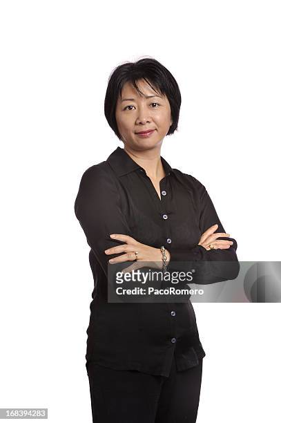 asian executive displaying confidence with arms crossed - asian woman black shirt stock pictures, royalty-free photos & images