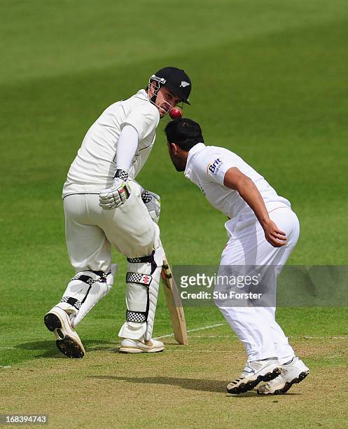 New Zealand batsman Hamish Rutherford looks on as England bowler Ravi Bopara appears to balance the ball on his head during day one of the tour match...