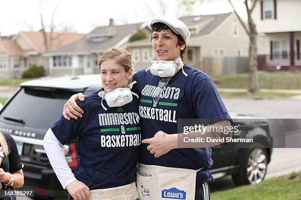 Lindsay Whalen and Janel McCarville of the Minnesota Lynx share a laugh while on a construction crew of female volunteers in support of Habitat for...