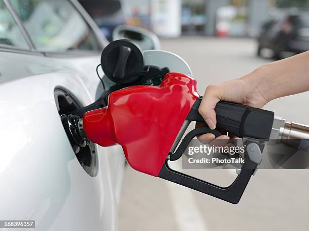 refueling at gas station - xxxxxlarge - red car stock pictures, royalty-free photos & images