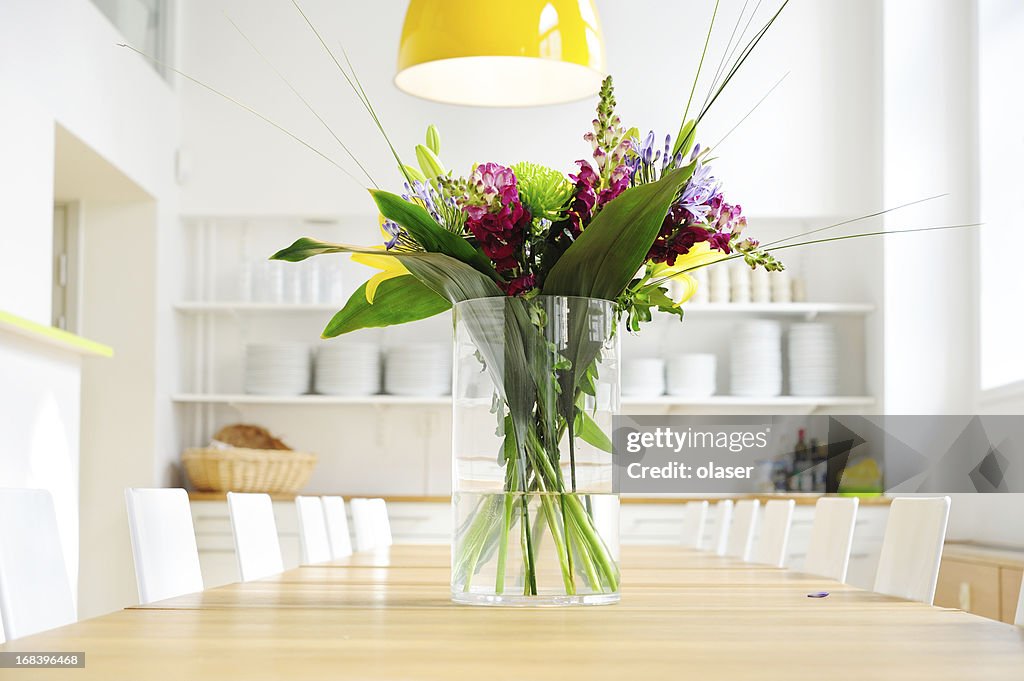 Flowers on table in bright large kitchen