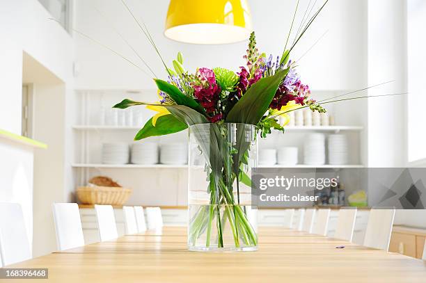 flowers on table in bright large kitchen - new flooring stock pictures, royalty-free photos & images