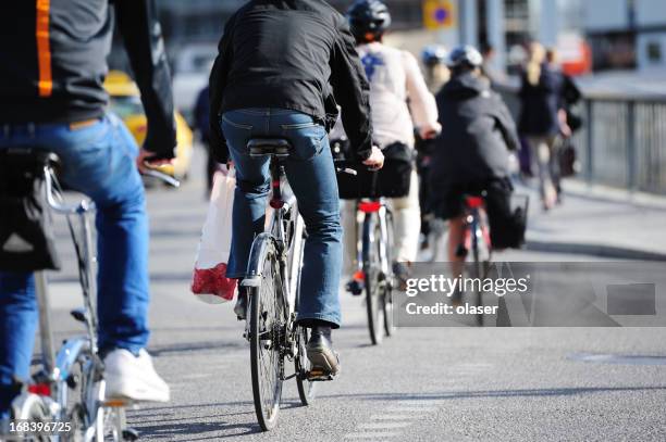 bikes in traffic - biking city stock pictures, royalty-free photos & images