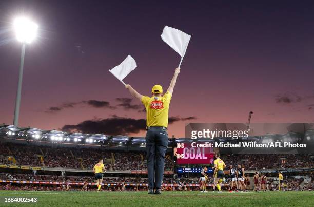 The goal umpire waves his flags during the 2023 AFL Second Preliminary Final match between the Brisbane Lions and the Carlton Blues at The Gabba on...