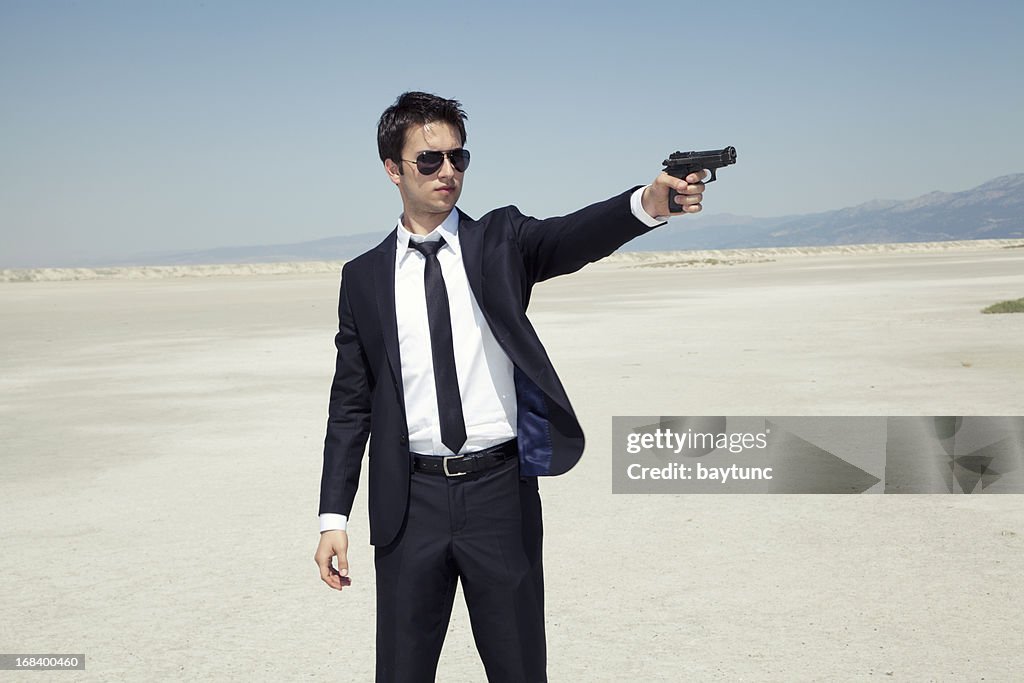 Businessman aiming a handgun