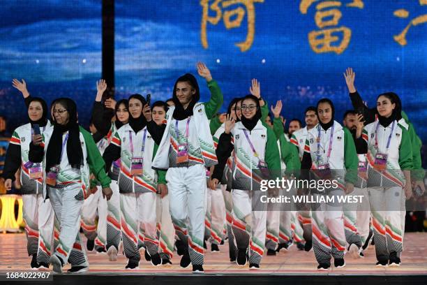Members of Afghanistan's delegation take part in the athletes parade during the opening ceremony of the 2022 Asian Games at the Hangzhou Olympic...