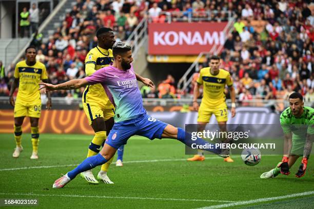 Milan's French forward Olivier Giroud tries to score during the Italian Serie A football match between AC Milan and Hellas Verona at San Siro stadium...