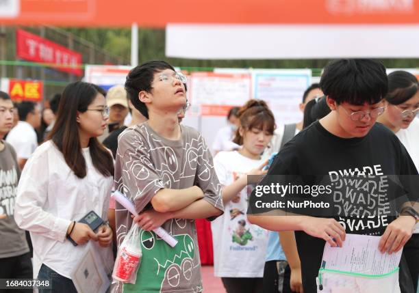 College students look at job openings in Qingdao, Shandong province, China, Sept 23, 2023.