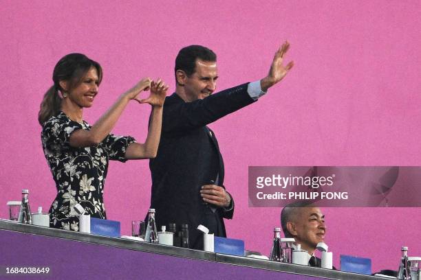 Syria's President Bashar al-Assad and his wife Asma al-Assad attend the opening ceremony of the 2022 Asian Games at the Hangzhou Olympic Sports...