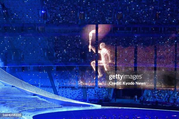 Virtual torchbearer is projected during the opening ceremony of the Asian Games at Hangzhou Olympic Sports Centre Stadium in Hangzhou, China, on...