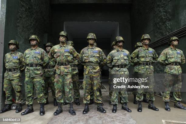 Army Soldiers stand guard during the Howitzer drill as part of their routine military training in Nangan on May 8, 2013 in Matsu, Taiwan. The...