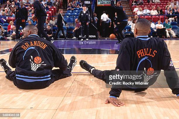 Terrell Brandon and Bobby Phills of the Cleveland Cavaliers stretch against the Sacramento Kings during a game played on March 11, 1997 at Arco Arena...