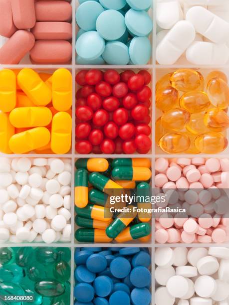 pills in container - vitamin a stock pictures, royalty-free photos & images